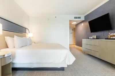 a hotel room with a bed and a flat screen tv at Fontainebleau in Miami Beach