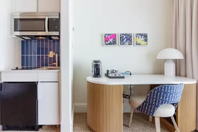 a kitchen with a desk and a chair and a microwave at Fontainebleau in Miami Beach