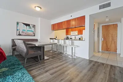 a kitchen and living room with a table and chairs at Upscale Apartment in the Heart of Brickell in Miami