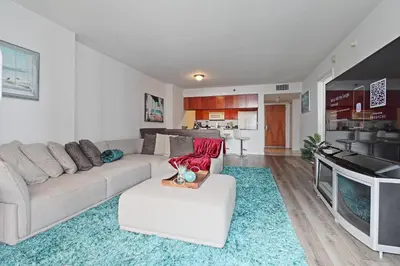 a living room with a couch and a kitchen at Upscale Apartment in the Heart of Brickell in Miami