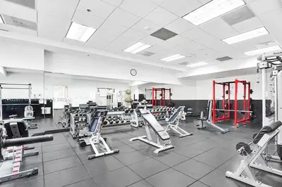 a gym with several treadmills and machines at Upscale Apartment in the Heart of Brickell in Miami