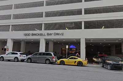 a group of cars parked in front of a building at Upscale Apartment in the Heart of Brickell in Miami