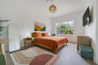 a bedroom with a bed and a television in it at Tropics Hotel Miami Beach in Miami Beach