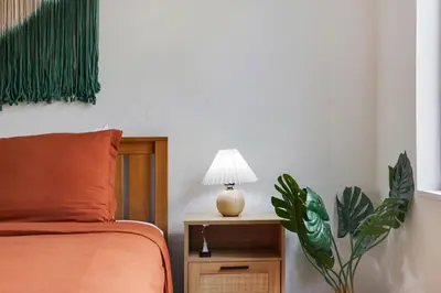 a bedroom with a bed and a table with a lamp at Tropics Hotel Miami Beach in Miami Beach