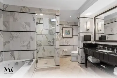 a bathroom with a tub and a sink and a toilet at FontaineBleau Resort Balcony w Ocean and City View in Miami Beach