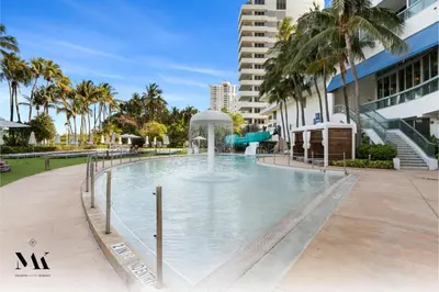 a swimming pool with a water slide in a building at FontaineBleau Resort Ocean plus Bay View w Balcony in Miami Beach