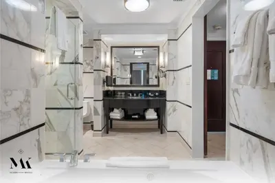 a bathroom with a tub and a sink and a mirror at FontaineBleau Resort Ocean plus Bay View w Balcony in Miami Beach