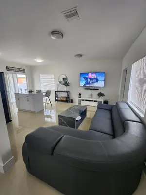 a living room with a black couch and a table at The 305 in Miami