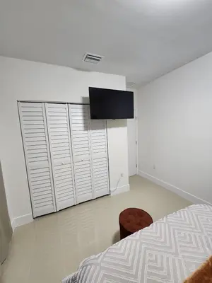 a bedroom with a bed and a tv on the wall at The 305 in Miami