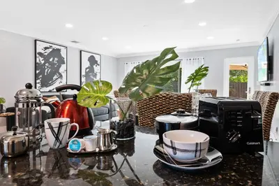 a living room with a table with cups and a microwave at Copacabana in Fort Lauderdale