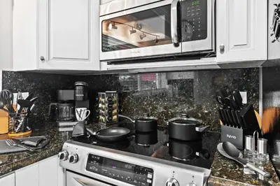 a kitchen with a stove and a microwave at Copacabana in Fort Lauderdale