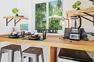 a kitchen with a counter with stools and a blender at Copacabana in Fort Lauderdale