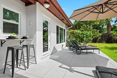 a patio with a table and chairs and an umbrella at Copacabana in Fort Lauderdale