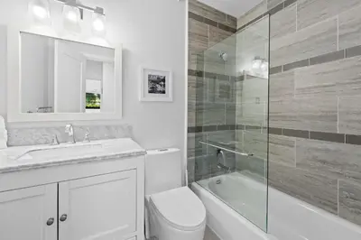 a bathroom with a toilet and a sink and a shower at 7 Minutes to Beach Saltwater Pool Open Floor Plan in Fort Lauderdale