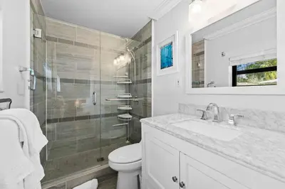 a bathroom with a toilet and a sink and a shower at 7 Minutes to Beach Saltwater Pool Open Floor Plan in Fort Lauderdale