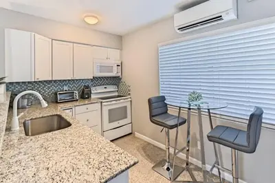 a kitchen with a sink and a table and chairs at WiltonPlex A in Fort Lauderdale