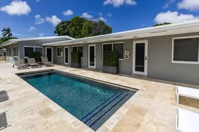 a swimming pool in front of a house at WiltonPlex A in Fort Lauderdale
