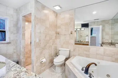 a bathroom with a tub and a toilet and a sink at Villa Fiesta - Celebrate Dreams Create Memories in Southwest Ranches