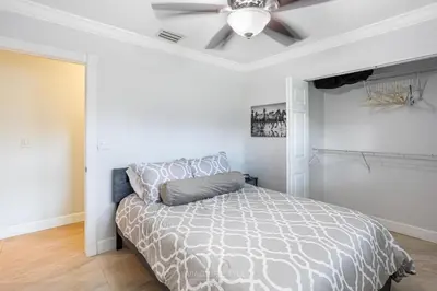 a bedroom with a bed and a ceiling fan at Villa Fiesta - Celebrate Dreams Create Memories in Southwest Ranches