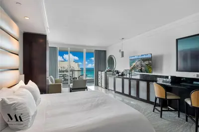 a hotel room with a large bed and a television at FontaineBleau Resort Balcony w Pool & Ocean View in Miami Beach