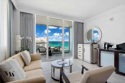 a living room with a couch and a table at FontaineBleau Resort Balcony w Pool & Ocean View in Miami Beach