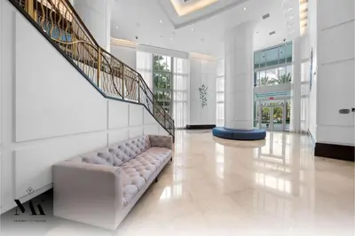 a living room with a couch and a staircase at FontaineBleau Resort High Floor w Ocean Views in Miami Beach