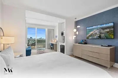a hotel room with a large bed and a tv at FontaineBleau Resort High Floor w Ocean Views in Miami Beach