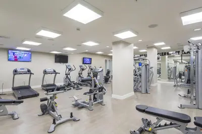 a gym with treadmills and elliptical machines at Coral Gables 2br w wd pool gym near shops MIA-83 in Miami