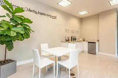 a dining room with a table and chairs and a kitchen at Coral Gables 2br w wd pool gym near shops MIA-83 in Miami