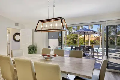 a dining room with a table and chairs at Lakefront Family Fun Home with Private Dock 3BR 2B in Fort Lauderdale