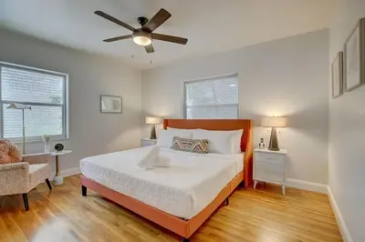 a bedroom with a bed and a ceiling fan at Tranquil Poolside Bliss Pergola Deck Turf Yard in Fort Lauderdale