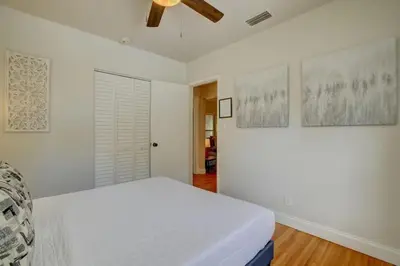 a white bedroom with a bed and a ceiling at Tranquil Poolside Bliss Pergola Deck Turf Yard in Fort Lauderdale