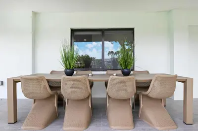 a dining room table with chairs and a large window at The World's Mansion - Game Room, 9 Bedrooms, Htd Pool, Mini Golf, BBQ in Tamiami