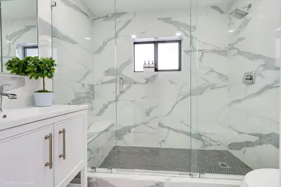 a bathroom with a shower with a glass door at The World's Mansion - Game Room, 9 Bedrooms, Htd Pool, Mini Golf, BBQ in Tamiami