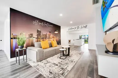 a living room with a couch and yellow pillows at The World's Mansion - Game Room, 9 Bedrooms, Htd Pool, Mini Golf, BBQ in Tamiami