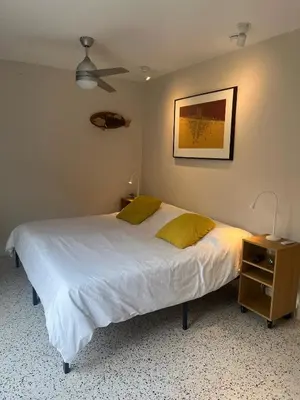 a bedroom with a white bed with a nightstand and a bed sidx sidx sidx at Cozy house close Brickell in Miami