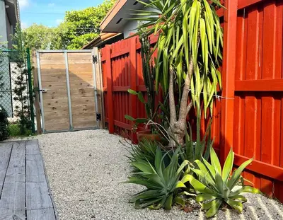 a red fence with a gate and a wooden door at Cozy house close Brickell in Miami