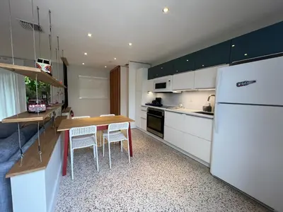 a kitchen with a table and a white refrigerator at Cozy house close Brickell in Miami