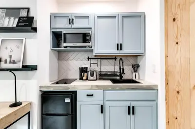 a white kitchen with a sink and a microwave at Coral Way Studio in quiet area Fast Internet Shen 1 in Miami