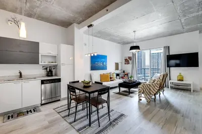 a kitchen and living room with a table and chairs at Beautiful Loft in Downtown Miami For 4 people 2208 in Miami
