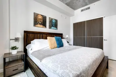 a bedroom with a large bed with a wooden headboard at Super convenient 1br apartment in Downtown 4 p 1708 in Miami