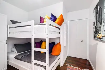 a room with two bunk beds with colorful pillows at Stylish 2br Apt in Downtown City View 3208 in Miami