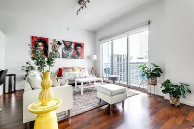 a living room with a white couch and a large window at Stylish 2br Apt in Downtown City View 3208 in Miami