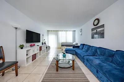 a living room with a blue couch and a table at Ocean Reserve in Sunny Isles Beach