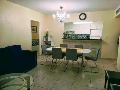 a kitchen and dining room with a table and chairs at Ocean Reserve in Sunny Isles Beach