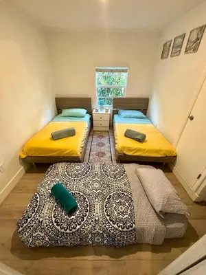 two beds in a small room with a window at Nice 2 Twin bedroom - Best central location in Miami - Luggage storage, parking and Laundry for free!!!! in Miami