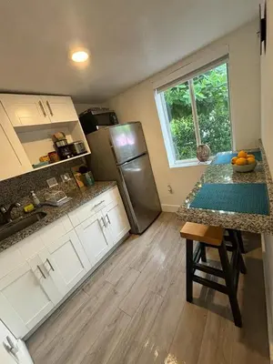 a kitchen with a counter top and a refrigerator at Nice 2 Twin bedroom - Best central location in Miami - Luggage storage, parking and Laundry for free!!!! in Miami