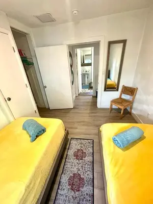 a bedroom with two beds and a chair in it at Nice 2 Twin bedroom - Best central location in Miami - Luggage storage, parking and Laundry for free!!!! in Miami