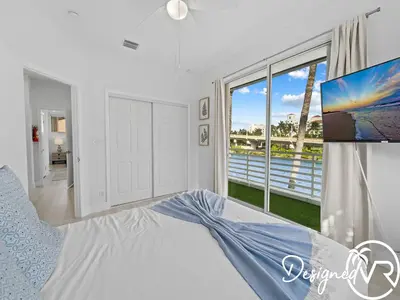 a bedroom with a bed and a large window at Villa wpool spa game room in Hollywood