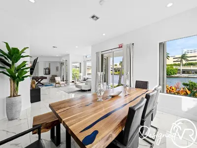a dining room with a wooden table and chairs at Villa wpool spa game room in Hollywood